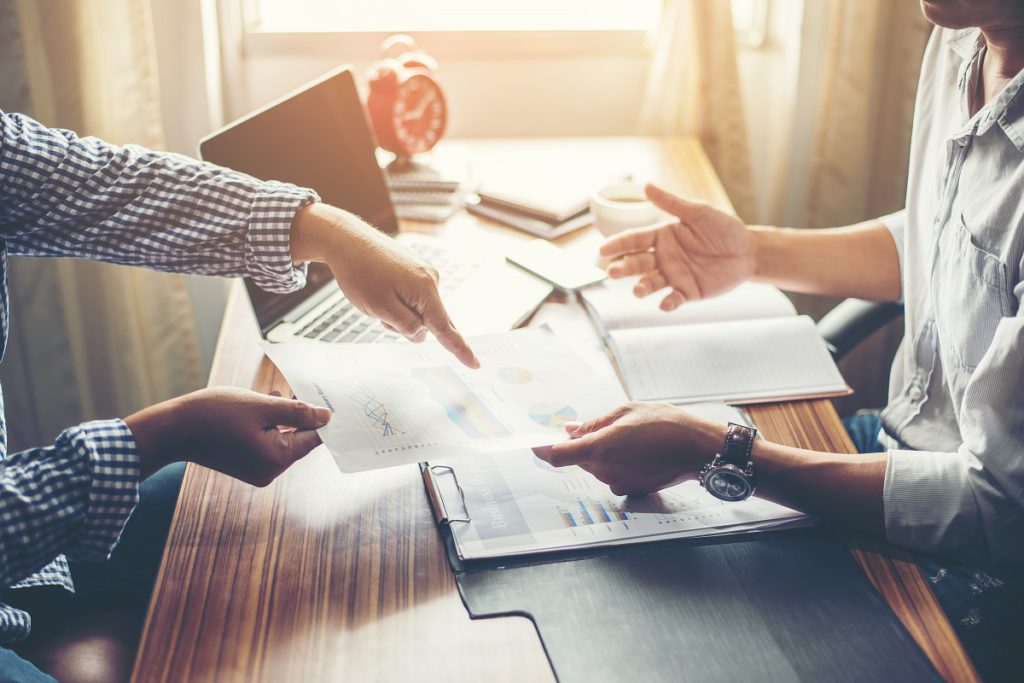 Close-up of Team Business people discussing a financial plan at office.